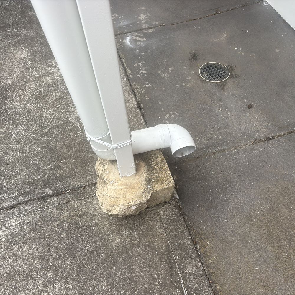 Damp brickwork and paving at the base of a wall, found during a building and pest inspection in Braybrook