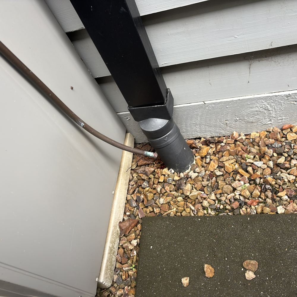 Downpipes emptying beside the footings and wetting the soil, found during a defect investigation inspection in South Kingsville