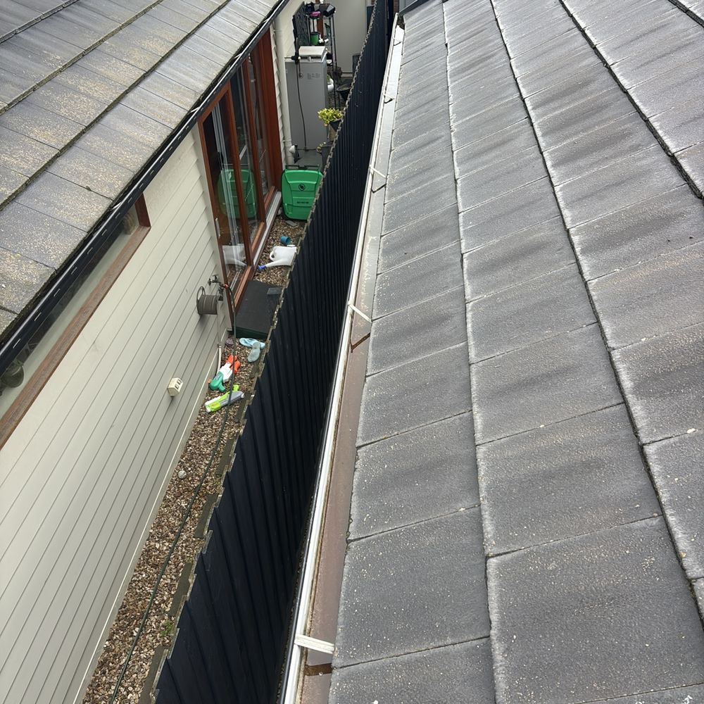 Gutter poorly installed, risking corrosion of the fascia behind it, found during a defect investigation inspection in South Kingsville