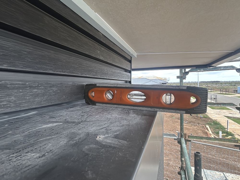 Parapet capping without the five degree fall it needs to shed water, Manor Lakes