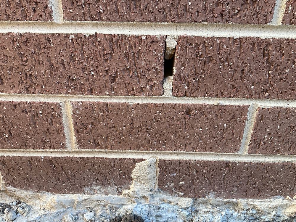 Weep holes filled with mortar on a finished home, found during a pre-handover (PCI) inspection in Manor Lakes